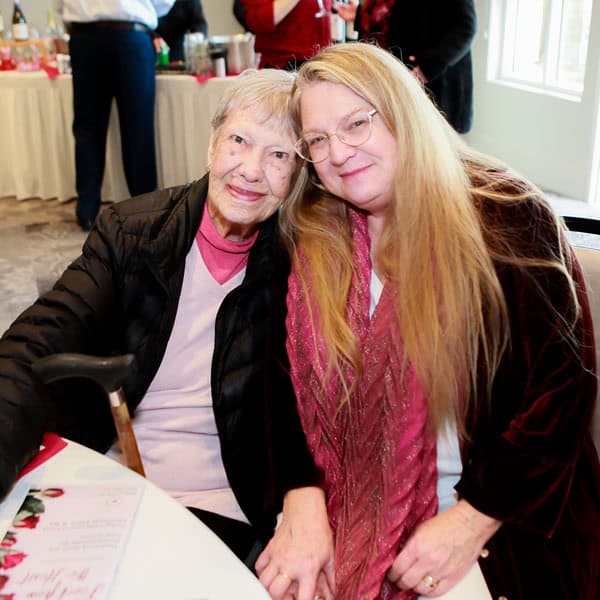 two people sitting and smiling