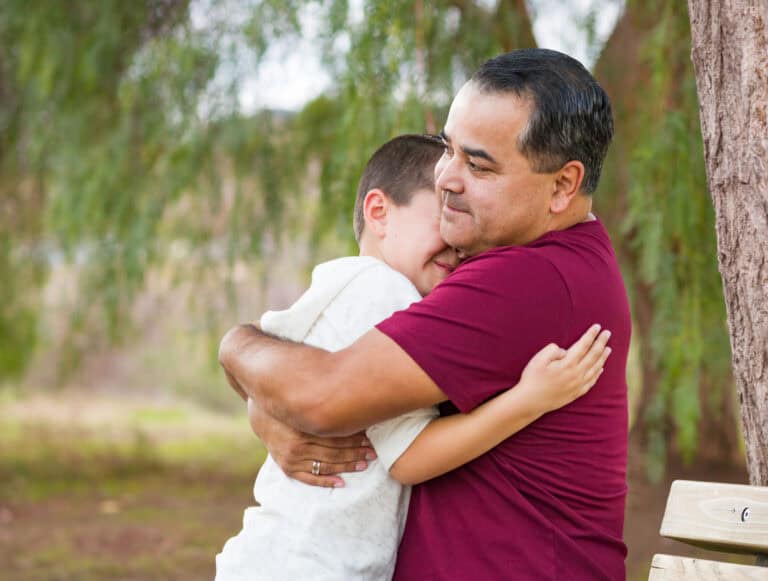 parent hugging child outdoors
